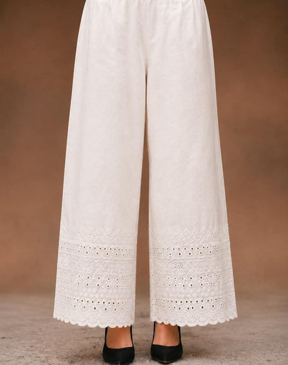  white soft cotton trousers with intricate chicken embroidery work and scalloped lace detailing along the hem, stylish comfortable women’s trousers, all sizes available.